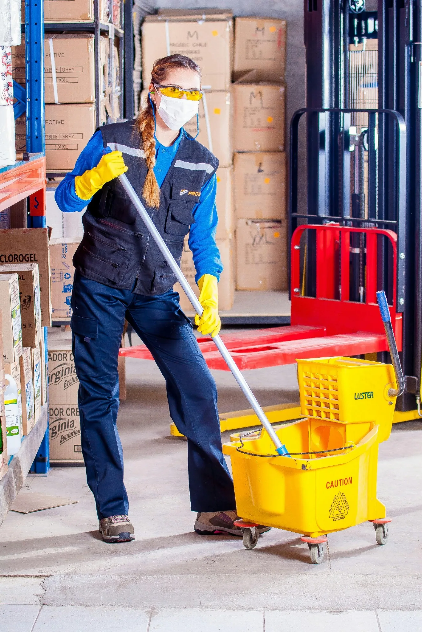 Cleaner working in a warehouse office area